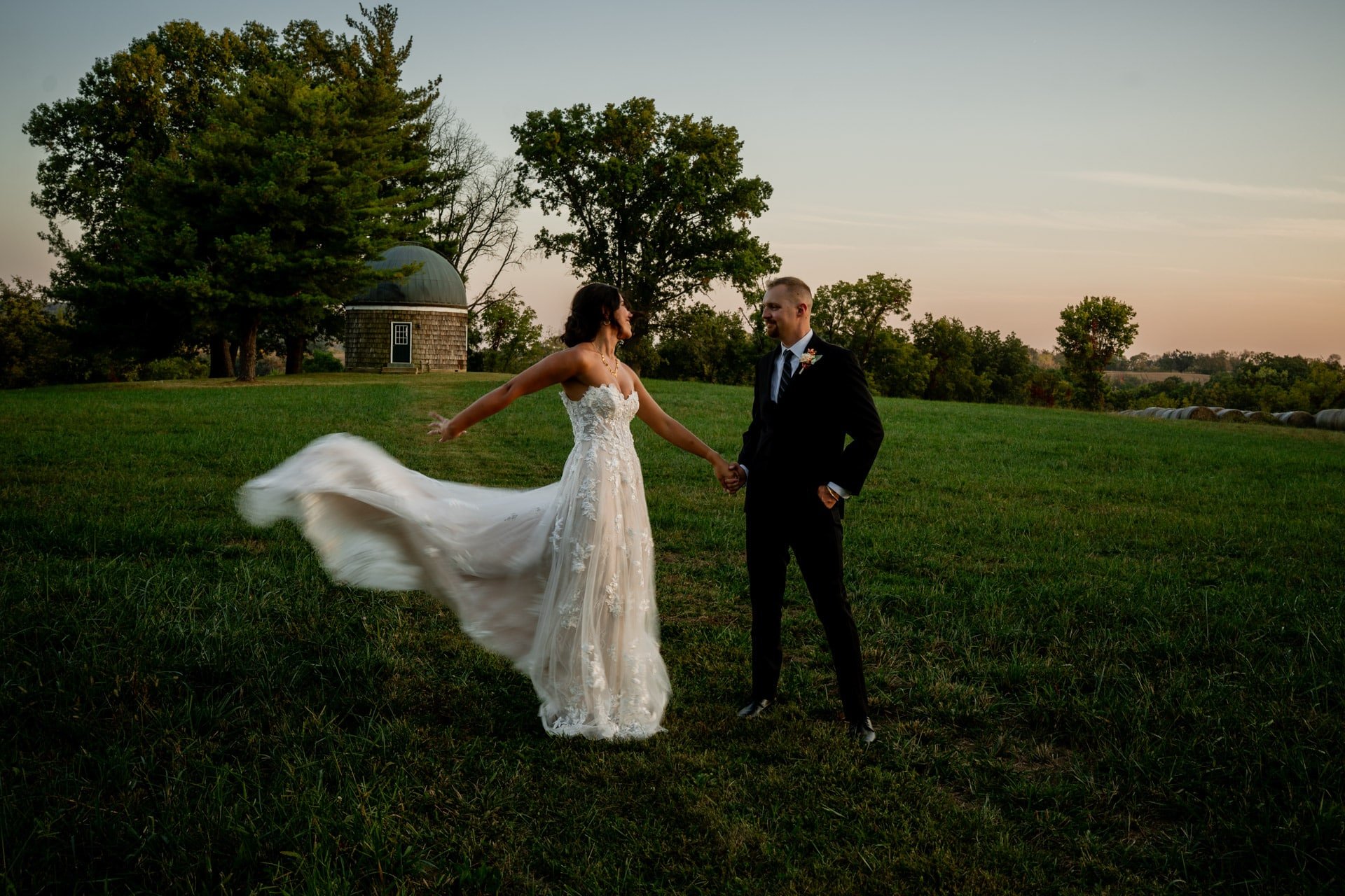 bride twirling groom smiling