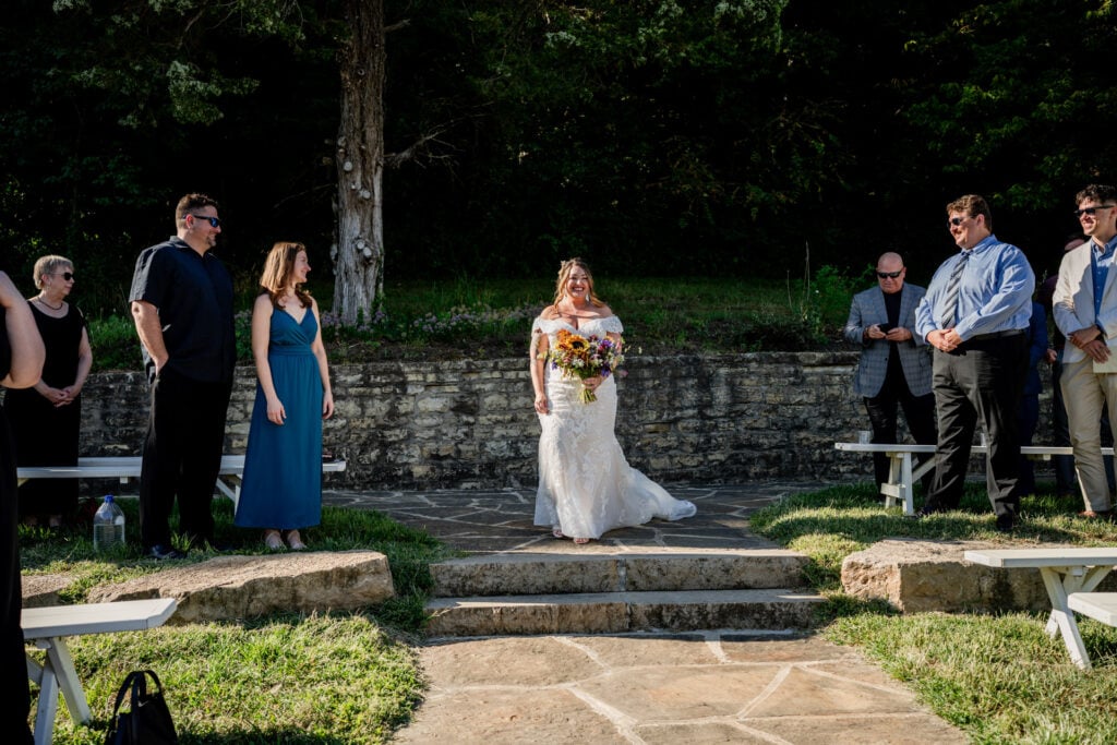 Sun Flower Hill Farm bride walking down aisle outdoors smiling guests